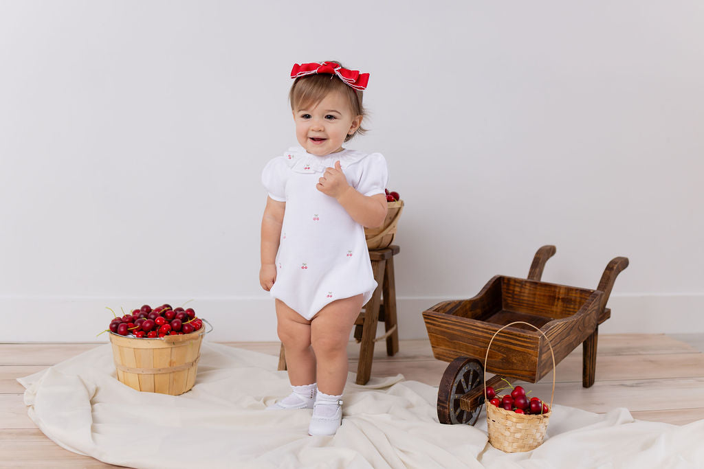 CERISE EMBROIDERED ROMPER